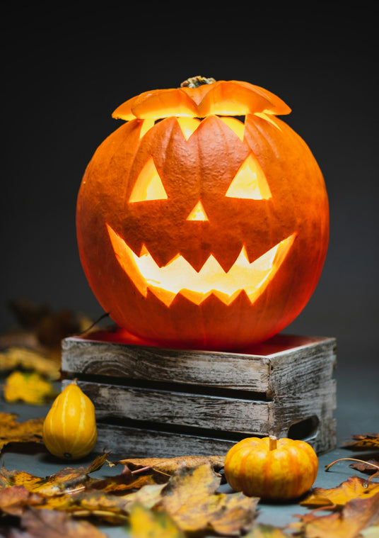 Lit jack-o'-lantern on a wooden table