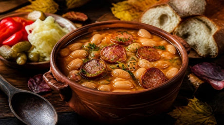Romanian white bean stew with smoked sausage in a clay pot